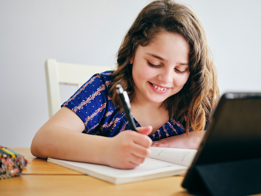 Young girl learning to read with an online program. 