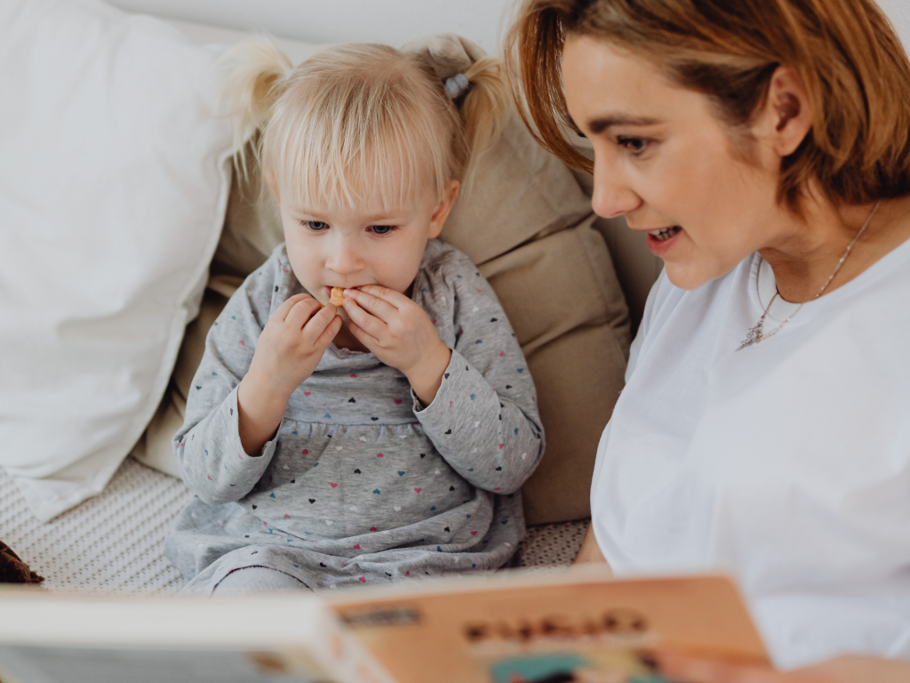 Mom reading to her young child. 