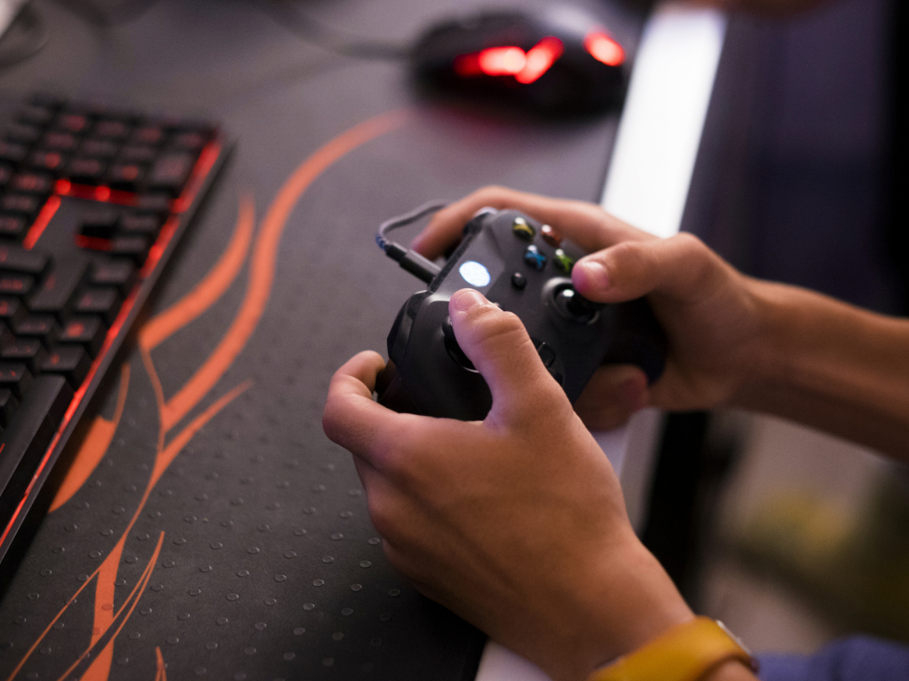 Hands on a gaming controller. 
